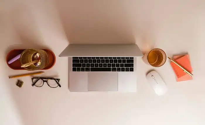 Top view of a home desk - laptop, notepad and the rest. Pinterest SEO tips.