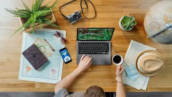 Top view of a blogger planning his coming travel blog post ideas.